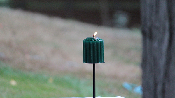 A candle burns during a memorial bench dedication ceremony for Prof. Troy Wolff, Sept. 18, 2014.