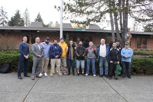 Shoreline Community College veteran students pose for a photo after raising the flags on Veterans Day 2015.