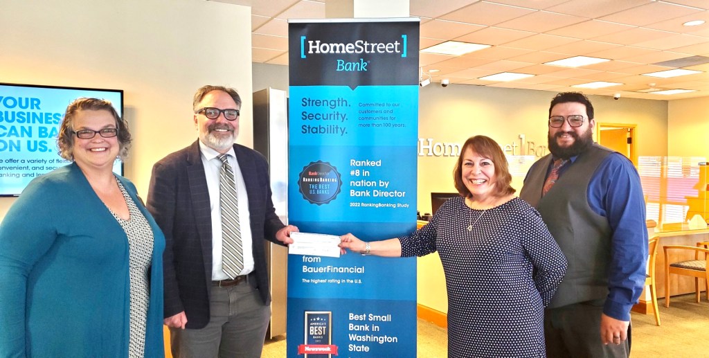 Dr. Kahn, Michelle Cimaroli and two folks from Home Street Bank receiving a donation check