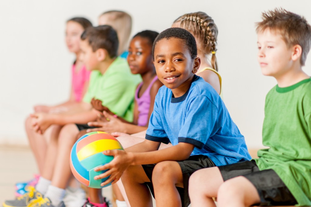 A group of kids having a rest after volleyball training
