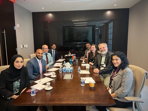 Dr. Kahn and Samira Pardanani sitting around a table with representatives from the UAE Education center at the NAFSA Conference in DC