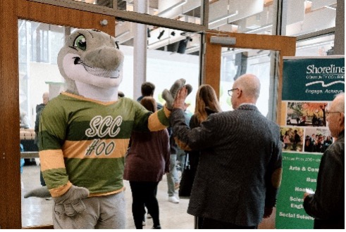 This is a picture of Dolphin high-fiving at the Foundation event