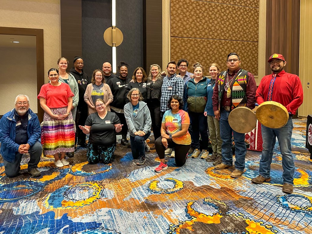A group of employees and representatives from the Muckleshoot Tribe posing together