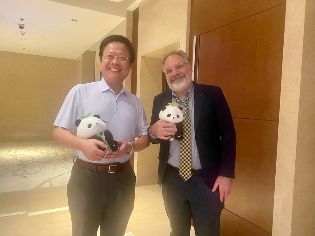 Dr. Kahn and Bo standing in the hallway holding stuffed pandas