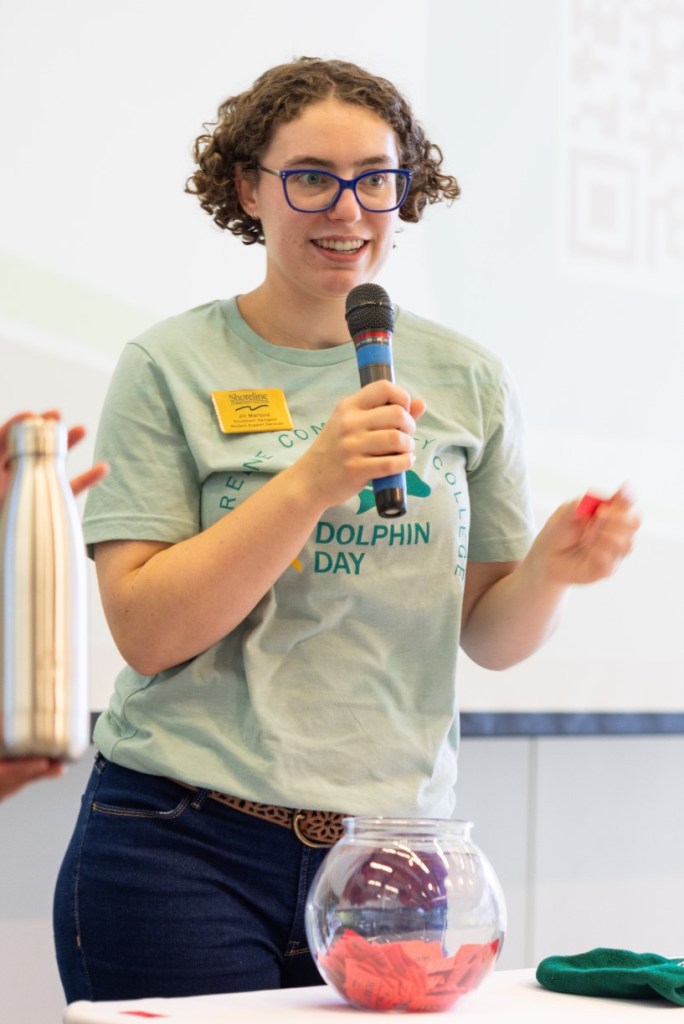 Jill speaking into a microphone at Dolphin Day.