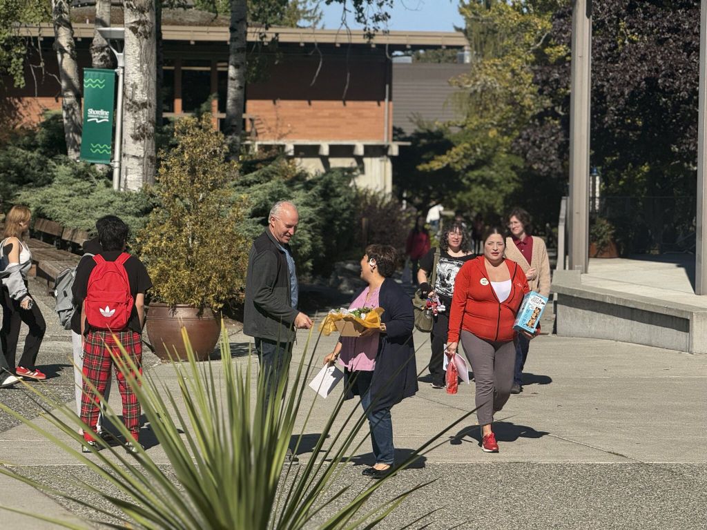 Staff and students walk across campus.