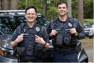 Photo of two officers in the new, dark blue Campus Safety uniforms. 