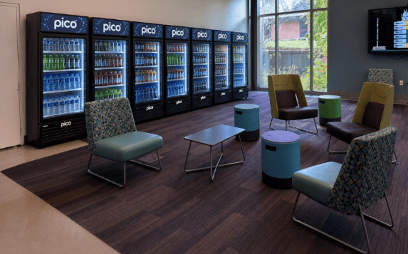 Generative AI picture showing proposed placement of up to 6 Avanti Market PICO 360 Coolers along the south wall in the seating area of Maple Student Union, Building 9000.