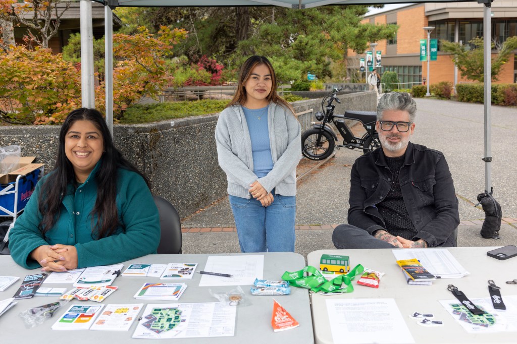 Volunteers sitting at the Ask Me desk.